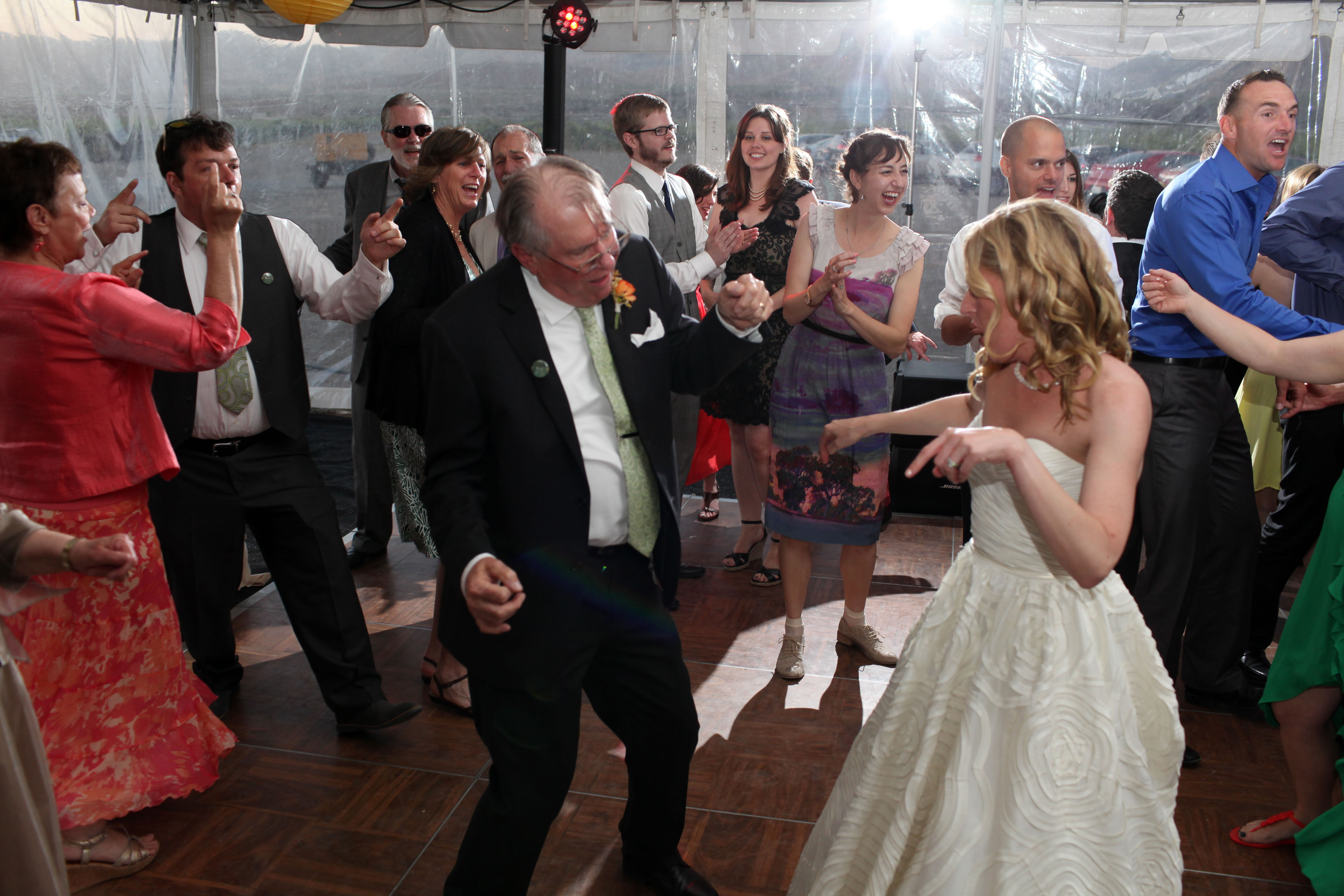 Packed dance floor under a tent at a wedding with DJ JAS