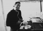 Wedding guests dancing under a tent with DJ JAS