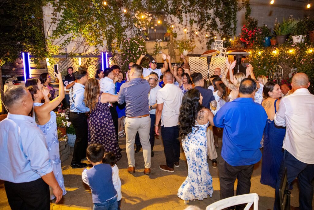 Guests dancing on the garden patio at an Arnoldi's Cafe wedding reception in Santa Barbara