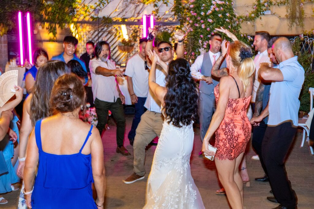 Bride dancing with guests on the patio dance floor at Arnoldi's Cafe, Santa Barbara