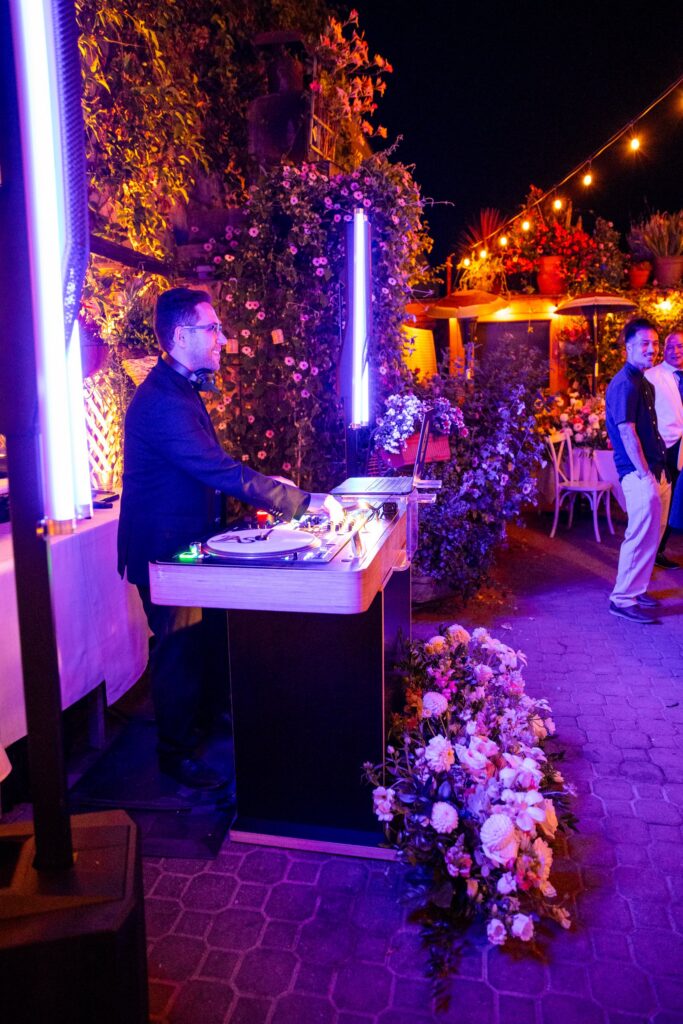 DJ JAS at his DJ booth with LED light columns on the patio at Arnoldi's Cafe, Santa Barbara