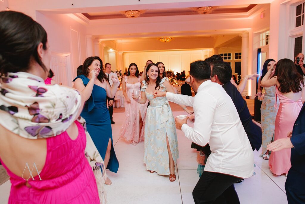 Guests dancing in a circle on the dance floor at Sherwood Country Club